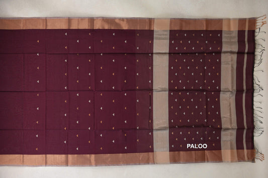 Deep wine maroon Maheshwari silk cotton saree laid out with small triangular motifs, warm-toned borders and a striped pallu with tassels.