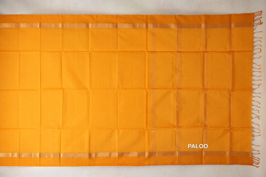 Mango yellow Maheshwari silk cotton saree spread flat, showing a plain pallu, narrow patterned borders and tassels at one end.