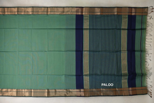 Sea green Maheshwari silk cotton saree laid flat, showing gold zari borders and a navy blue and sea green striped pallu with tassels.