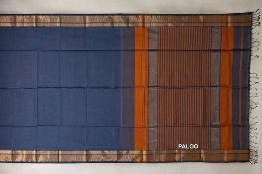 Dark grey blue Maheshwari silk cotton saree spread flat, showing a plain body, deep orange striped pallu, woven borders and tassels.