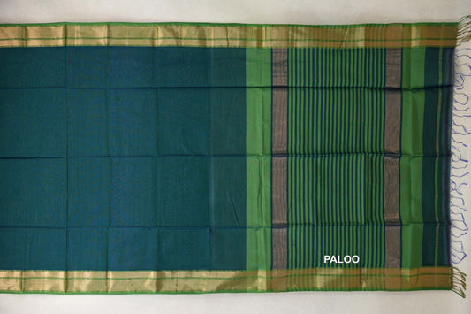 Maheshwari silk cotton saree laid flat, with a peacock blue body, leaf green and gold-toned borders, and a deep peacock blue pallu with leaf green stripes.