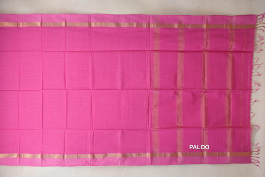 Bright Rani Pink Maheshwari silk cotton saree spread out, with pink borders, gold-toned bands, a striped pallu and tassels at the end.