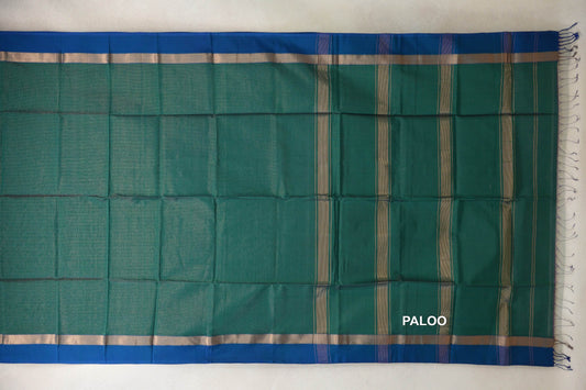 Laid-flat Maheshwari silk-cotton saree with a bottle green body, peacock blue borders, and a striped pallu with tassels.