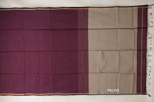 Maheshwari silk cotton saree laid flat, showing a wine maroon body, sand beige pallu, narrow striped borders and a fringed end.
