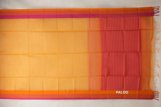 Mango yellow Maheshwari silk cotton saree laid flat, with orange and pink borders and a rani pink zigzag pallu with tassels.