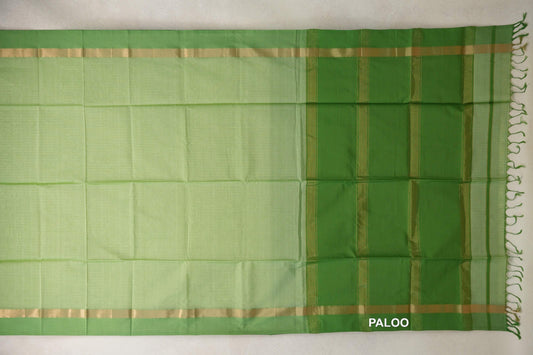 Unfolded pista green silk cotton saree with leaf green borders, gold-toned bands, and a striped leaf green pallu with tassels.
