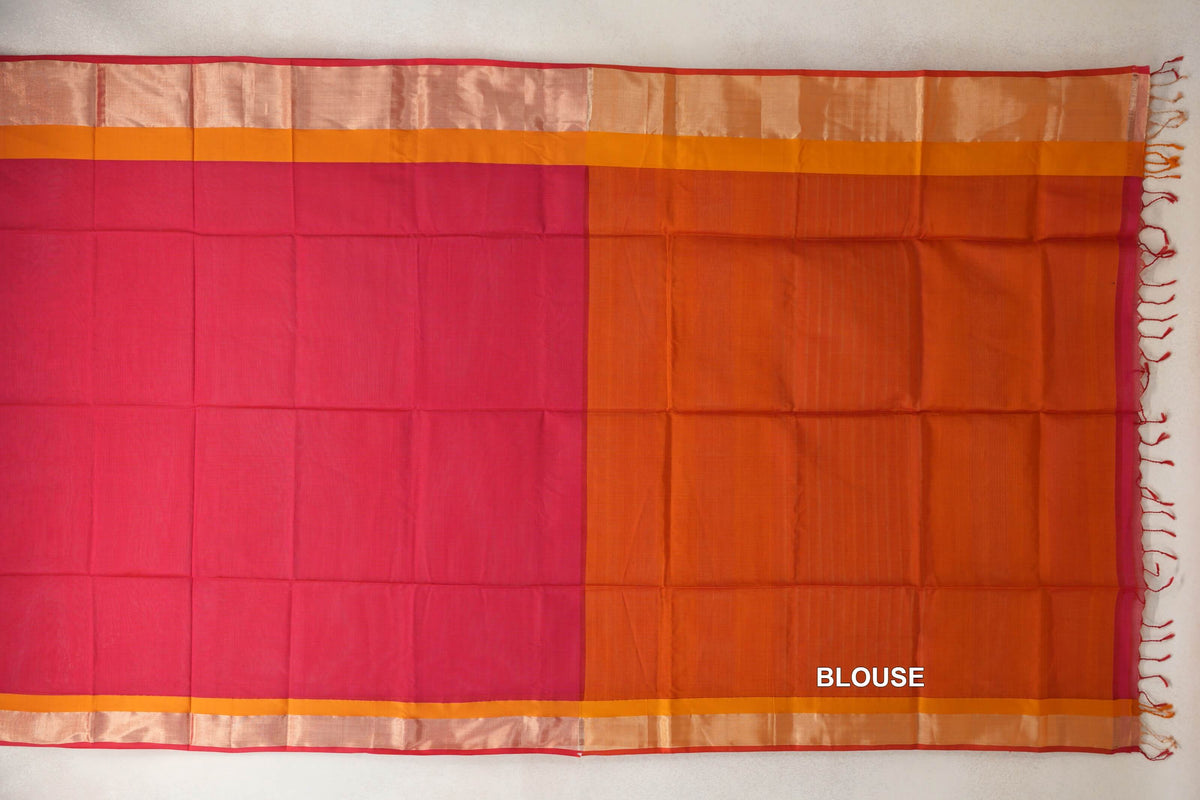Maheshwari silk cotton saree laid flat, with a deep rani pink body beside a deep orange blouse piece, orange borders, pinkish red edging and tassels.