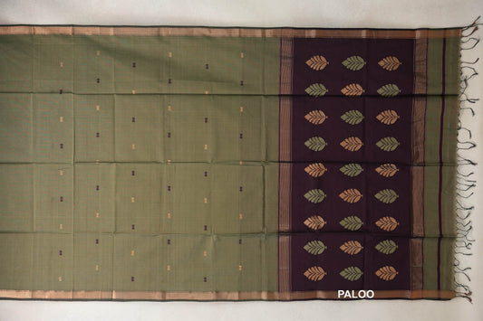 Muted olive green Maheshwari silk cotton saree spread flat, with small scattered motifs and a deep wine plum pallu with rows of leaf motifs and tassels.