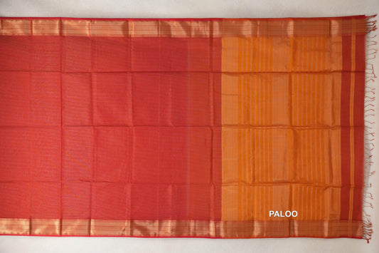 Tomato red Maheshwari silk cotton saree spread flat, with gold-toned woven border bands and a deep orange striped pallu with tassels.
