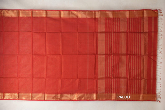 Tomato red Maheshwari silk cotton saree laid flat, with a plain body, gold-toned borders and a striped pallu ending in tassels.