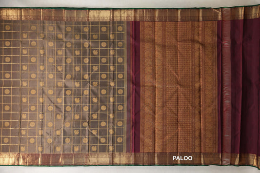 Spread-out olive green Kanjivaram silk saree with a gold checked body, deep maroon patterned pallu and gold borders edged in bottle green.