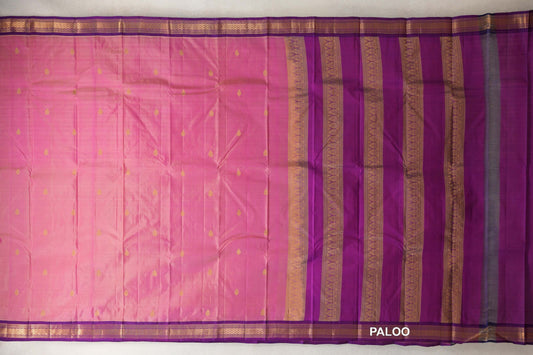 Lightweight Kanchipuram silk saree spread out, with a rose pink body dotted with gold motifs, purple borders and a purple pallu with gold patterned stripes.