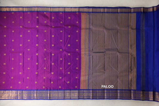 Lightweight Kanchipuram silk saree spread out, showing a rani pink body with small gold motifs, a patterned deep royal blue pallu and ornate borders.