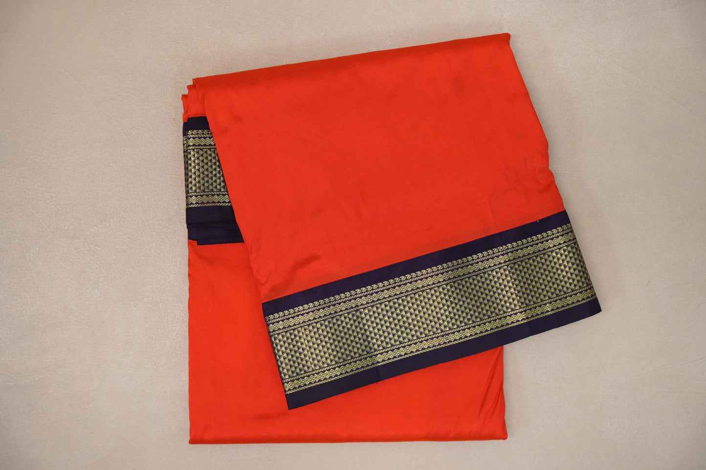 folded Reddish Orange Ten Yards Silk Cotton saree