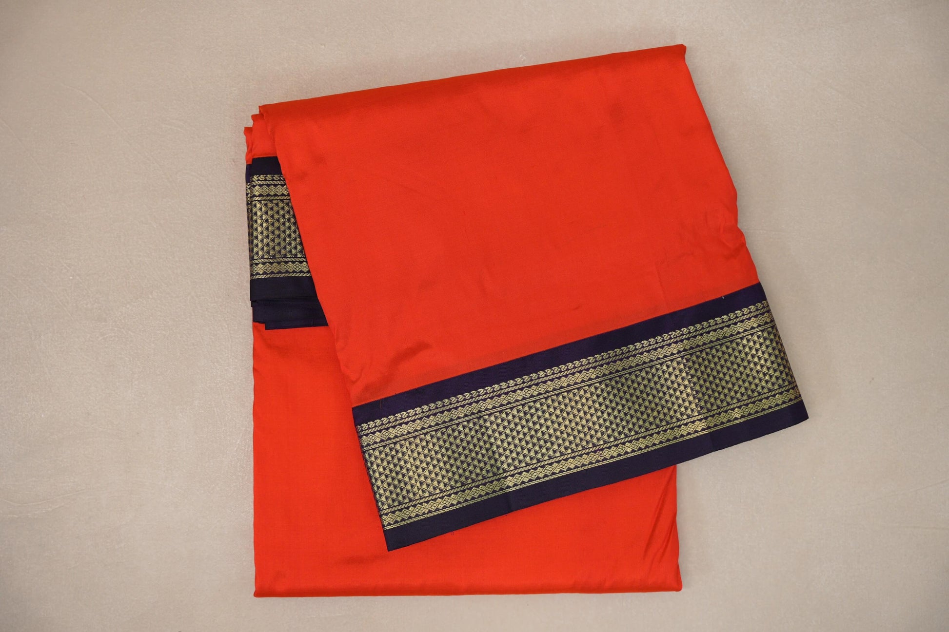 folded Reddish Orange Ten Yards Silk Cotton saree