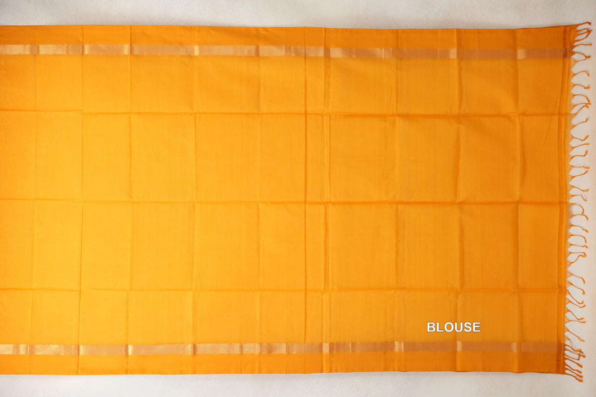Mango yellow Maheshwari silk cotton blouse fabric laid flat, with a plain body, narrow woven bands along both edges and tassels at one end.