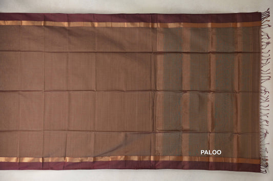 Maheshwari silk cotton saree spread flat, showing a beige body, vertically striped pallu, magenta borders, gold-toned bands and tassels.