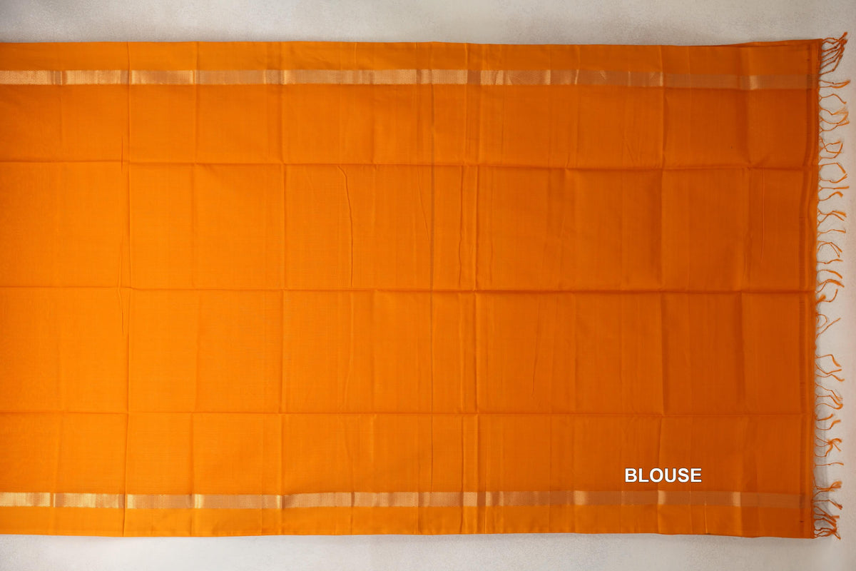 Mango yellow Maheshwari silk-cotton blouse fabric laid flat, with narrow patterned borders and tassels at one end.
