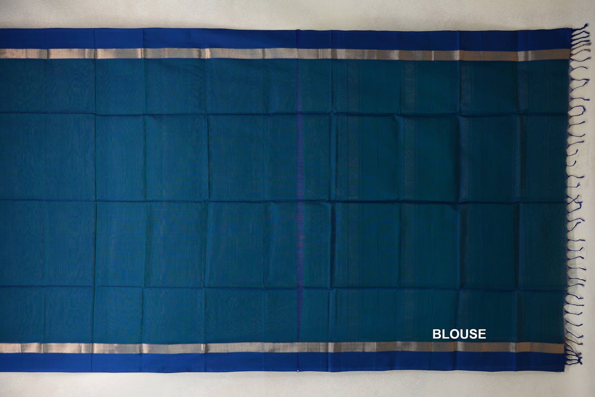 Blouse section of a Peacock Blue Maheshwari silk cotton saree laid flat, with deep blue borders, narrow metallic-patterned bands and tassels.