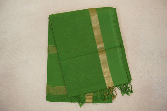 Folded leaf green Maheshwari silk cotton saree with a narrow gold zigzag stripe, fine striped border and green tassels.