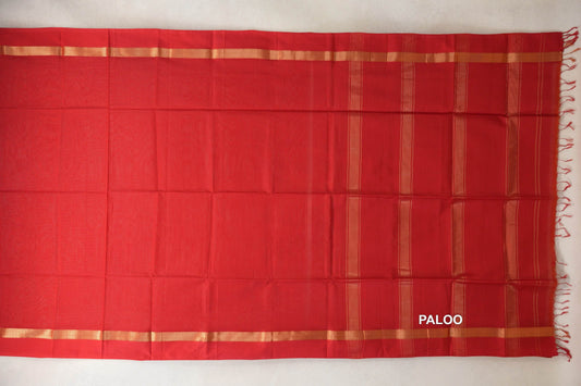 Vermilion red Maheshwari silk cotton saree laid flat, with a plain body, gold-toned borders and a striped pallu with red tassels.