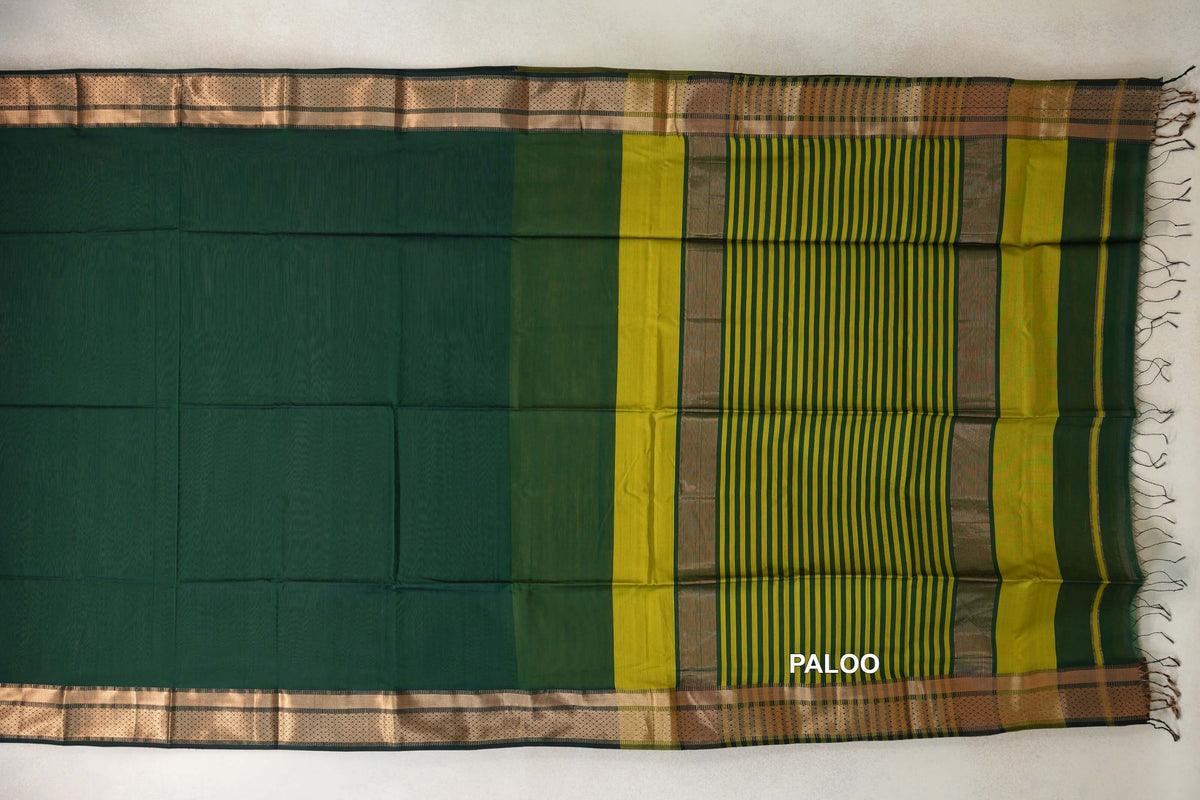 Maheshwari silk cotton saree laid flat, showing a bottle green body, patterned borders and an olive yellow striped pallu with tassels.