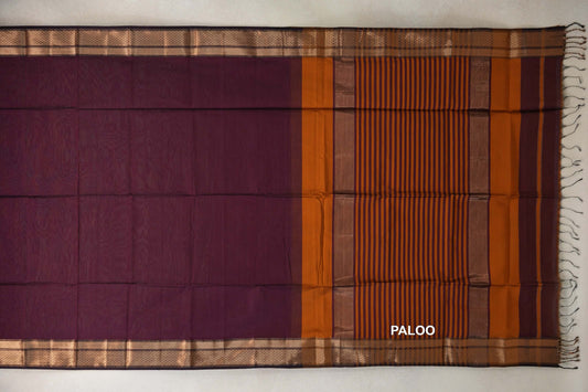 Maheshwari silk cotton saree laid flat, showing a deep plum body, gold-toned patterned borders and a deep orange striped pallu with tassels.