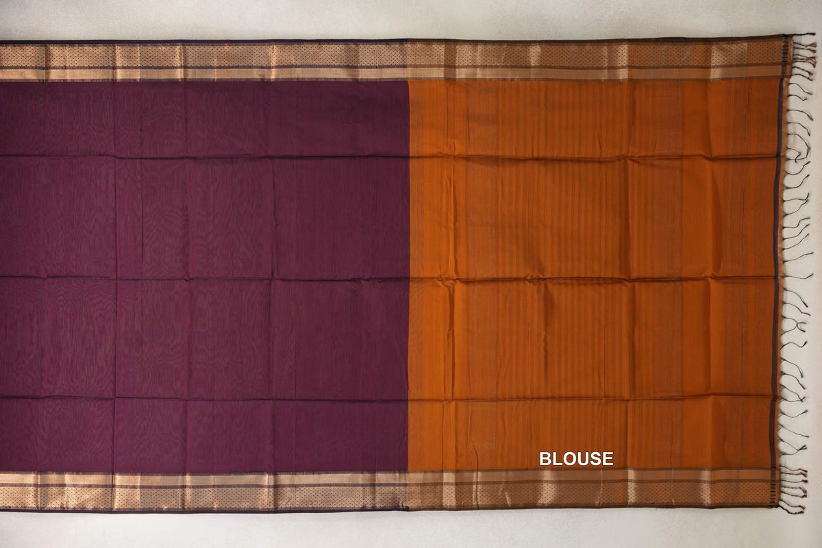 Maheshwari silk cotton saree laid flat, showing a deep plum body beside a deep orange blouse section, with patterned borders and tassels.