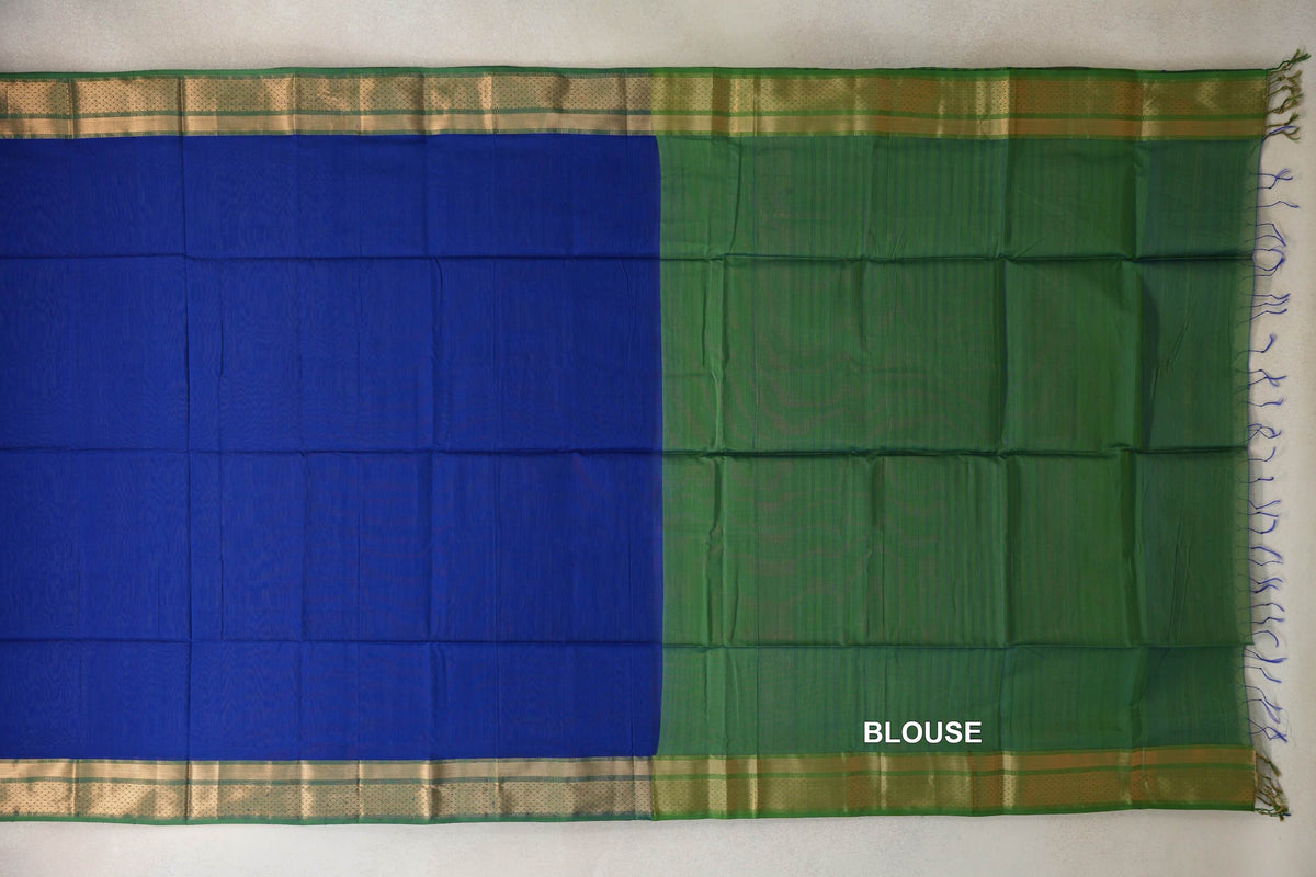 Laid-out Maheshwari silk cotton saree showing a bright royal blue body, leaf green blouse panel, green and gold-toned borders, and edge tassels.