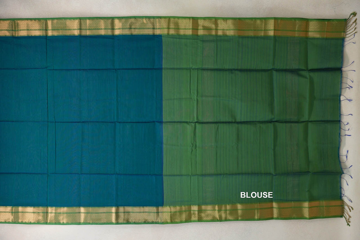 Maheshwari silk cotton saree spread flat, showing a peacock green body beside a leaf green blouse section, with gold-toned borders and tassels.