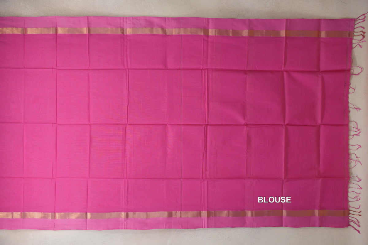 Bright Rani Pink Maheshwari silk cotton blouse piece laid flat, with gold-toned woven borders and pink tassels along one edge.