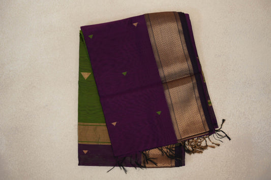 Folded deep purple Maheshwari silk cotton saree with small triangular motifs, a gold-toned chevron border, an olive green section and tassels.