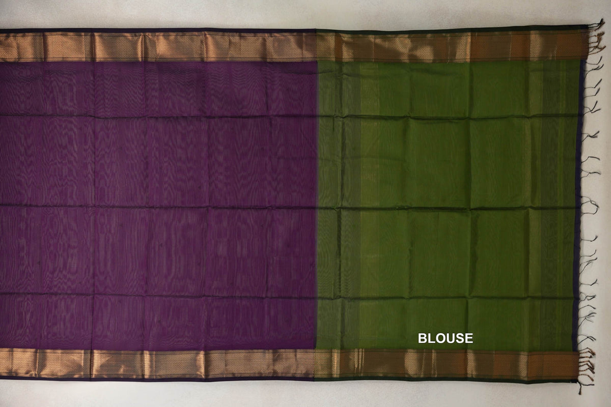 Laid-flat Maheshwari silk cotton saree showing a deep purple body beside an olive green blouse section, with patterned gold-toned borders and tassels.