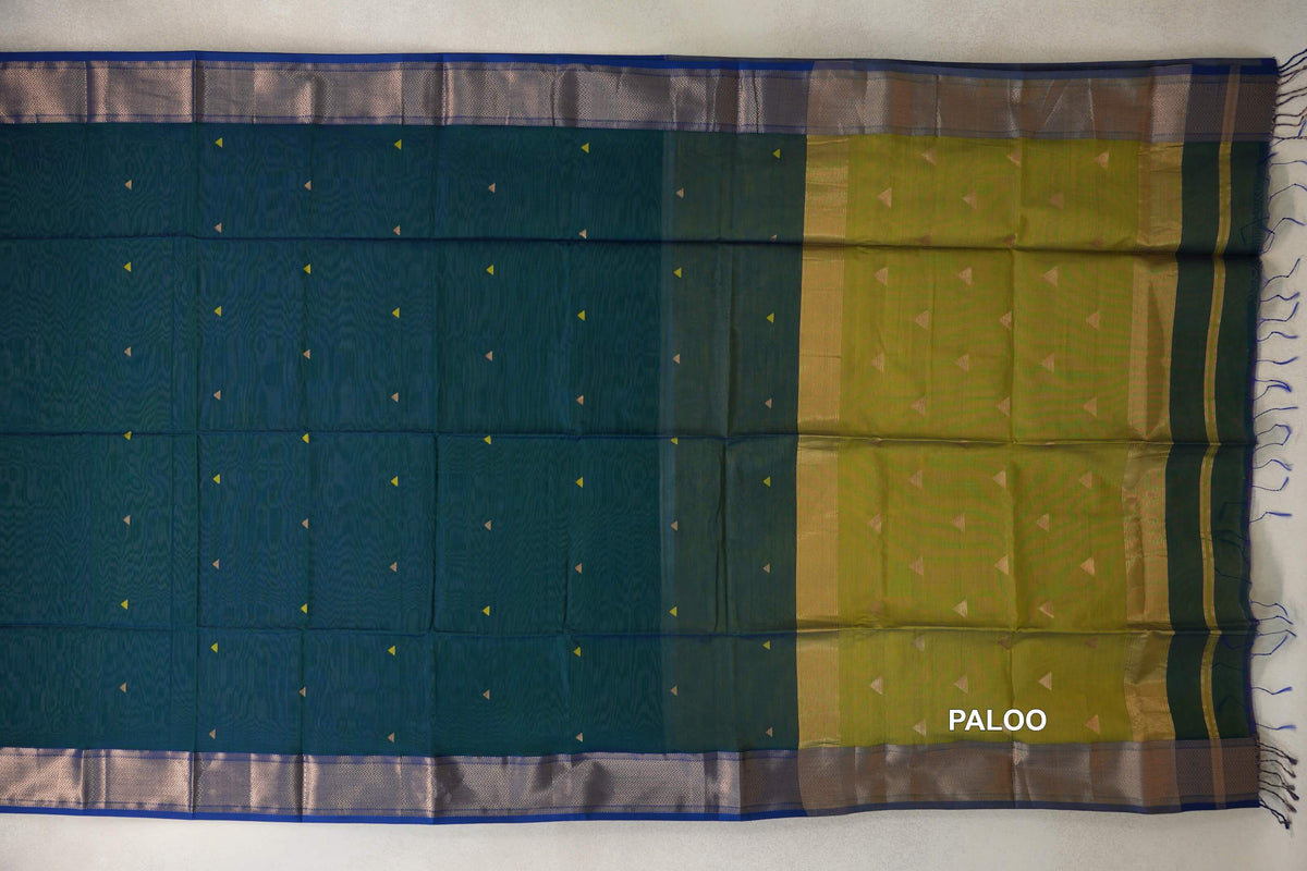 Maheshwari silk cotton saree spread flat, with a peacock green body, small triangular motifs, royal blue borders and a mehendi green pallu with tassels.