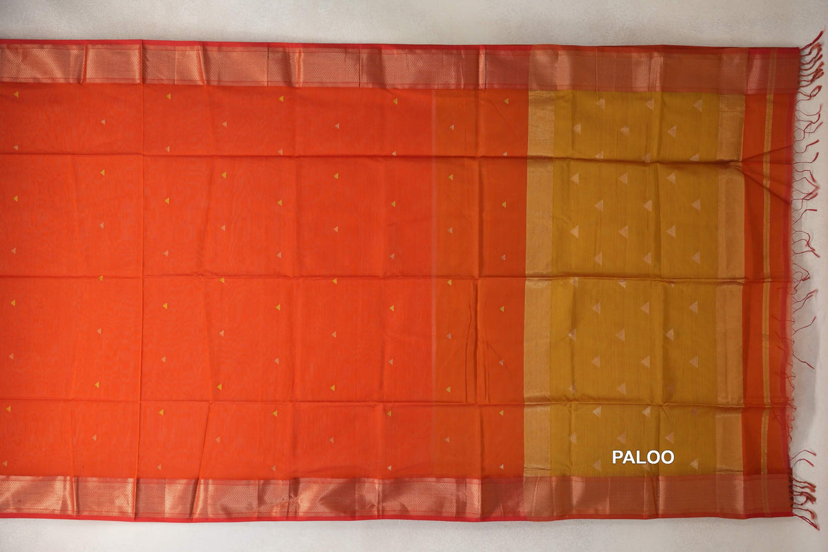 Spread-out Maheshwari silk cotton saree with a reddish orange body, small triangular accents, orangish red patterned borders and a mustard yellow pallu.