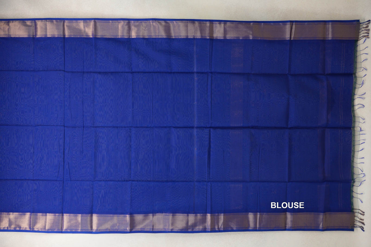 Royal Blue Maheshwari silk cotton blouse fabric laid flat, with subtle woven texture, silver-toned borders and blue tassels at one end.