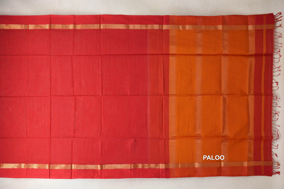 Maheshwari silk-cotton saree laid flat, showing a vermilion red body, narrow gold-toned border bands and a striped deep orange pallu with tassels.
