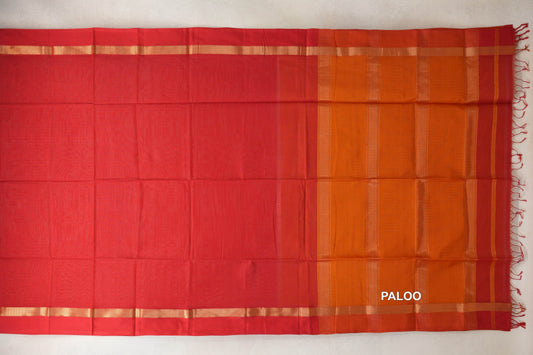 Maheshwari silk-cotton saree laid flat, showing a vermilion red body, narrow gold-toned border bands and a striped deep orange pallu with tassels.
