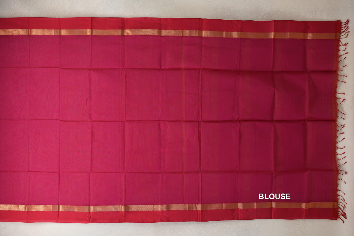 Blouse fabric laid flat in bright rani pink Maheshwari silk cotton, with deep rani pink borders, narrow gold-toned bands and tassels.