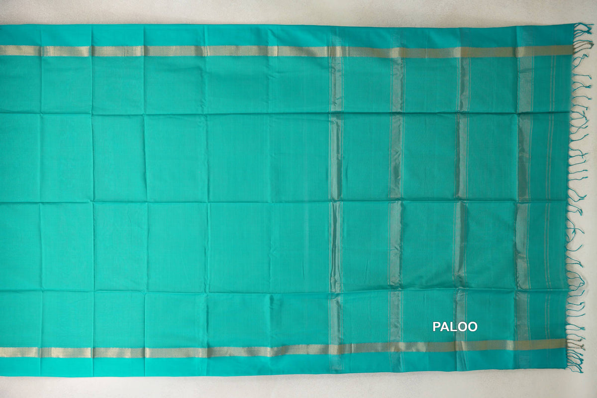 Bright Aqua Green Maheshwari silk-cotton saree spread flat, with silver-toned borders and a striped pallu ending in tassels.