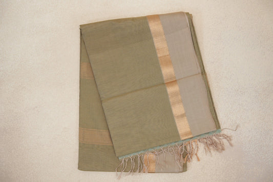 Folded light olive green Maheshwari silk cotton saree with fine stripes, a light beige border, gold zigzag detailing and tassels.