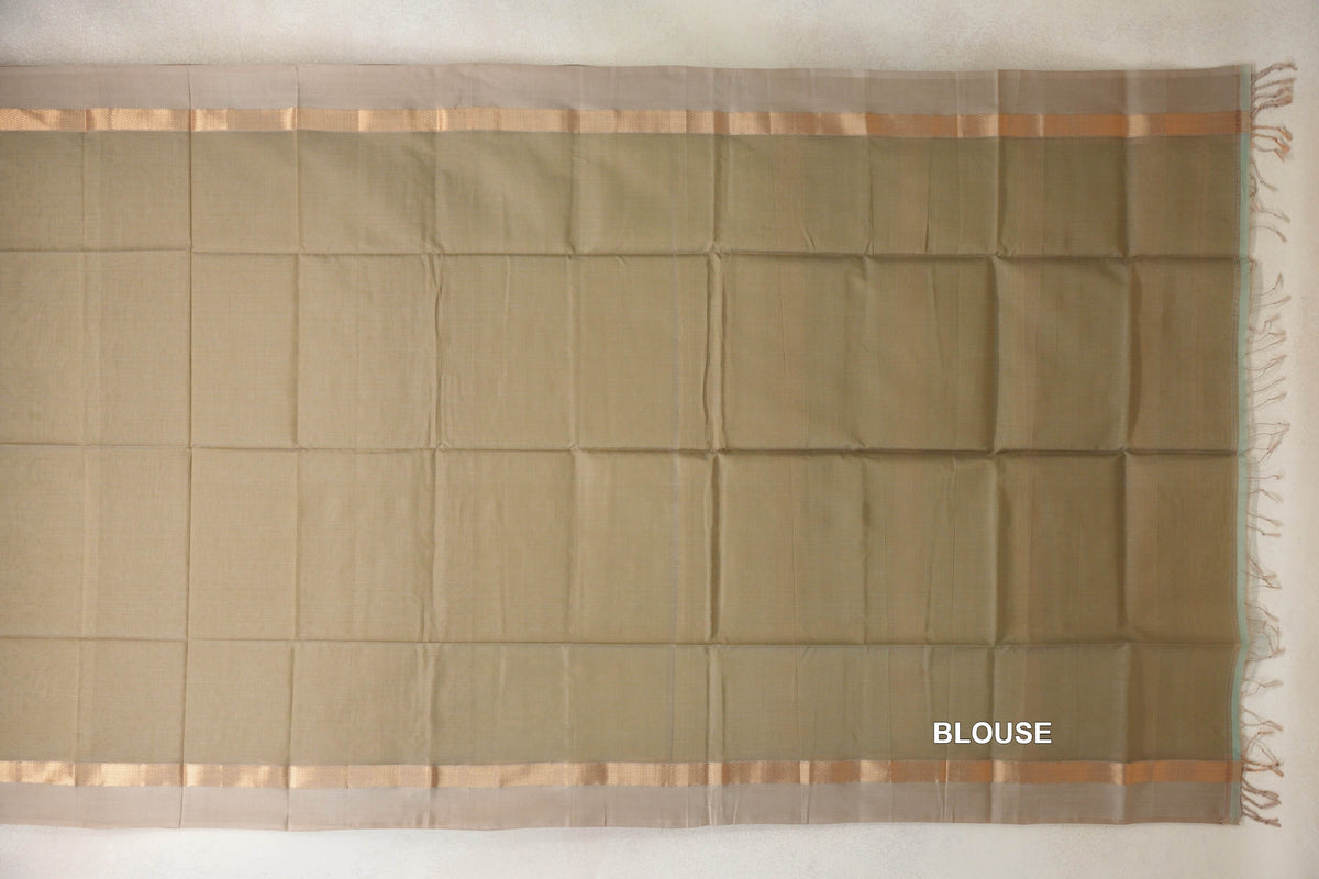 Light olive green Maheshwari silk cotton blouse piece laid flat, with light beige borders, narrow gold bands and tassels along one edge.