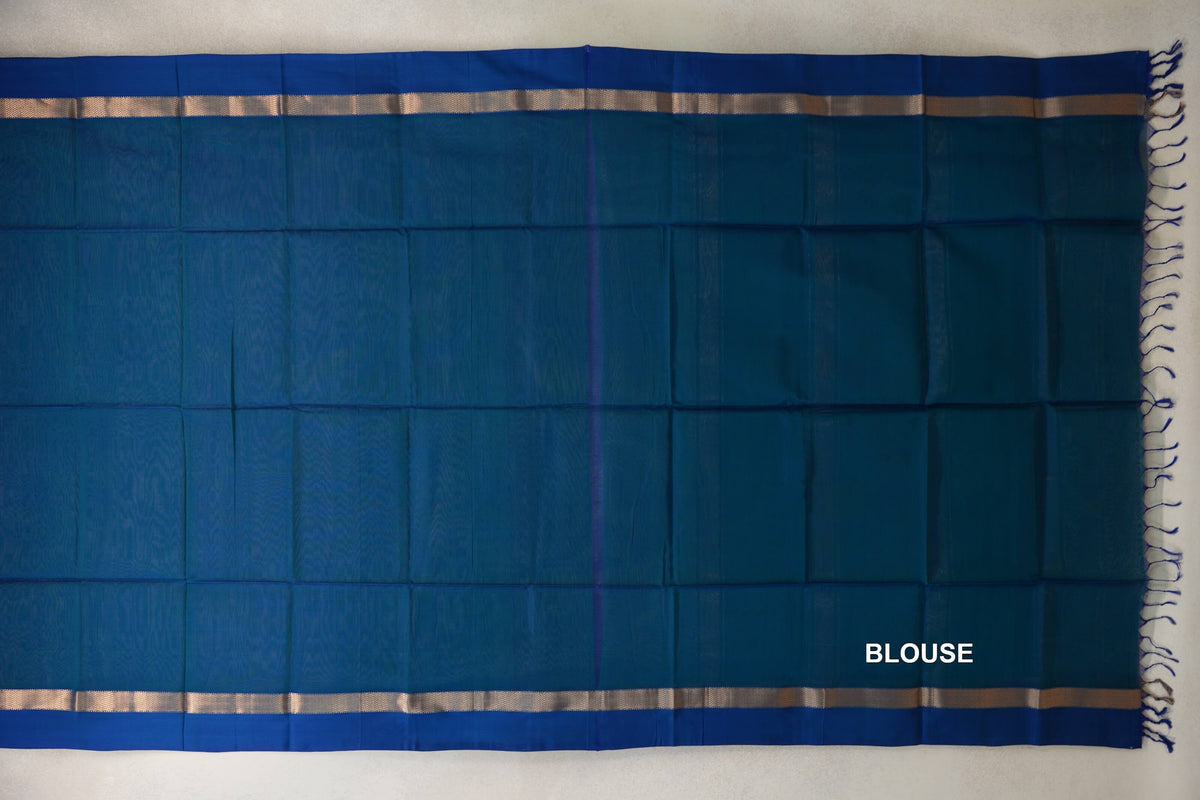 Peacock Blue Maheshwari silk cotton blouse piece laid flat, with Deep Peacock Blue borders, narrow metallic-patterned bands and tassels at one end.