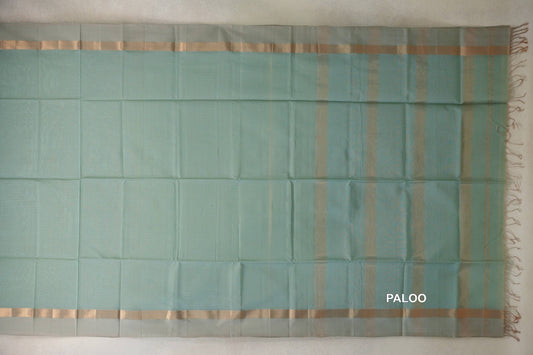 Sea green Maheshwari silk cotton saree laid flat, with light sandal beige borders and a gold zari-striped pallu with tassels.