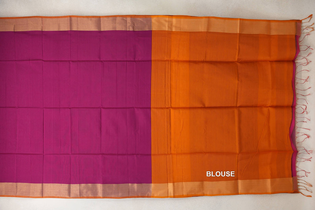 Deep magenta Maheshwari silk cotton saree laid flat beside deep orange blouse fabric, with pale borders, orange edging and tassels.