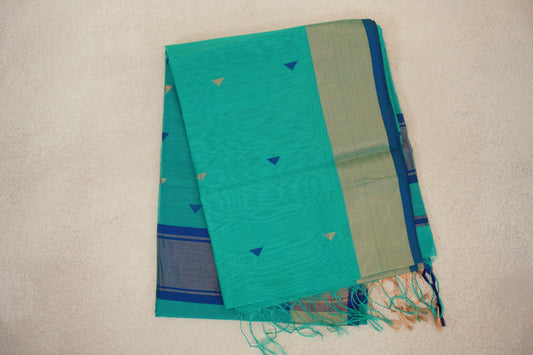 Folded sea green Maheshwari silk cotton saree with small blue and gold triangles, a pale gold border edged in blue, striped section and tassels.