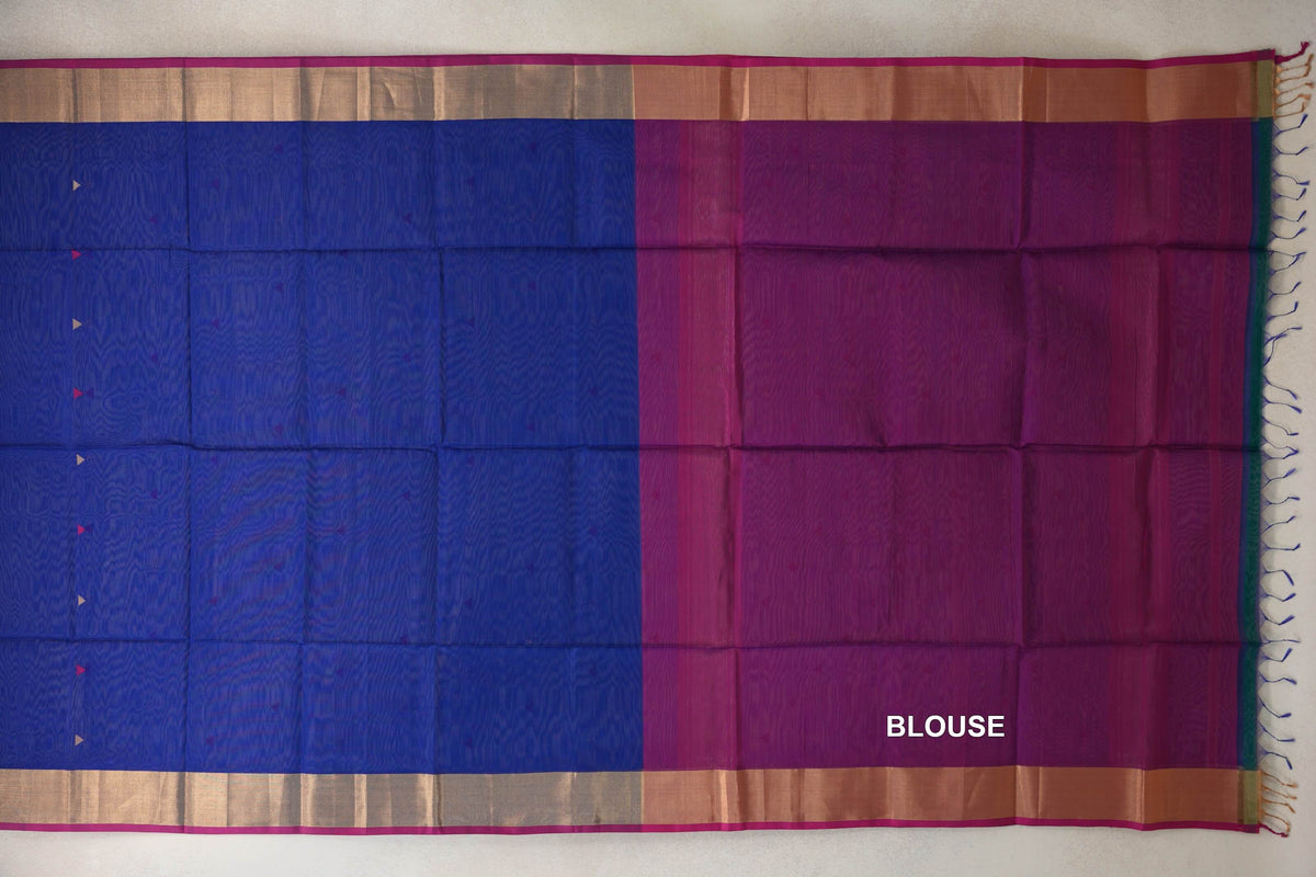 Maheshwari silk cotton saree laid flat, showing a bright royal blue body beside a rani pink blouse section, with gold-toned borders and tassels.