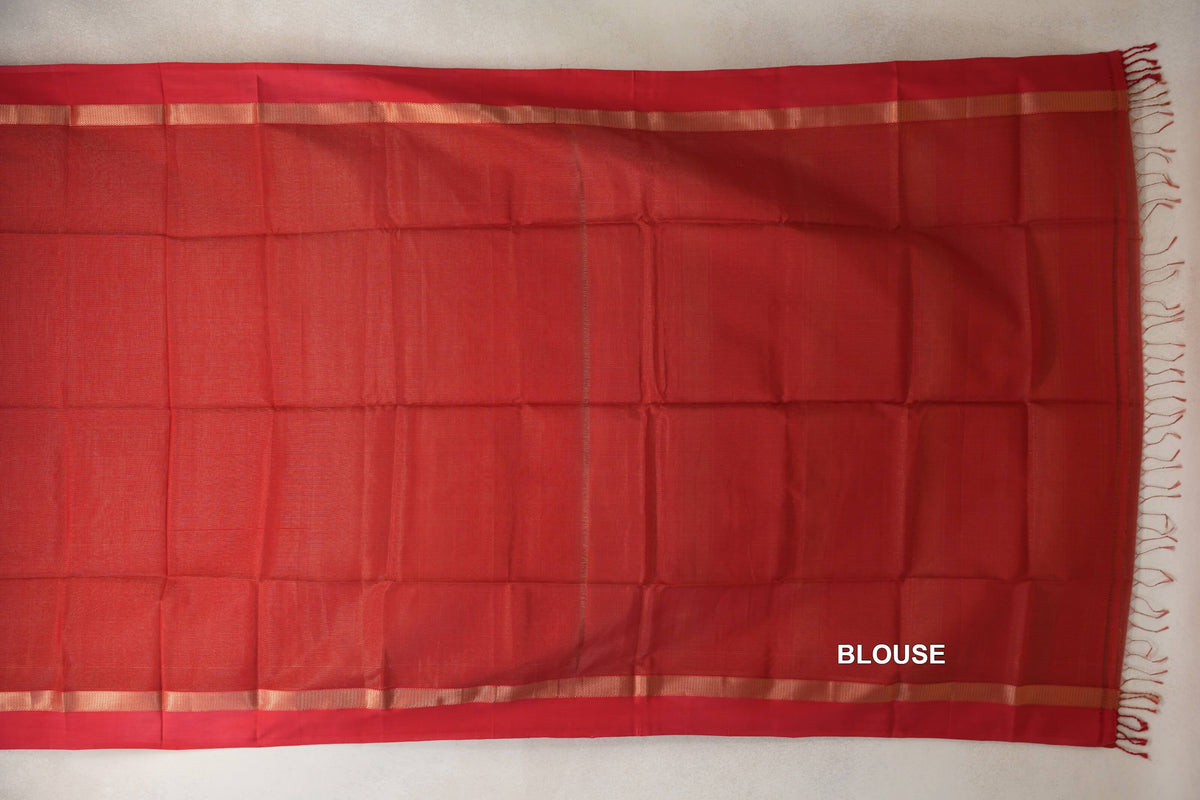 Tomato red Maheshwari silk cotton blouse fabric laid flat, with narrow gold-toned bands along the edges and red fringe at one end.