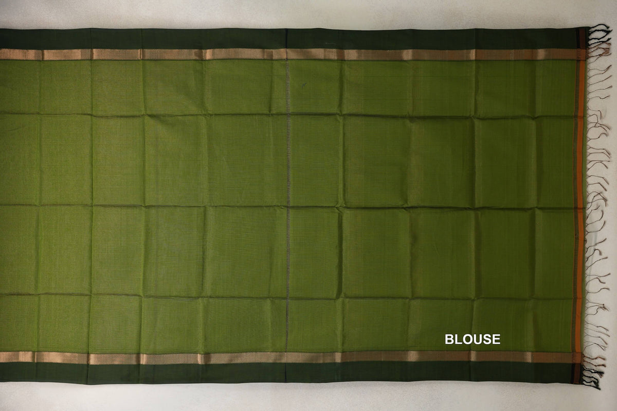 Olive green Maheshwari silk cotton blouse fabric laid flat, with deep forest green borders, narrow gold-toned stripes and tassels at one end.