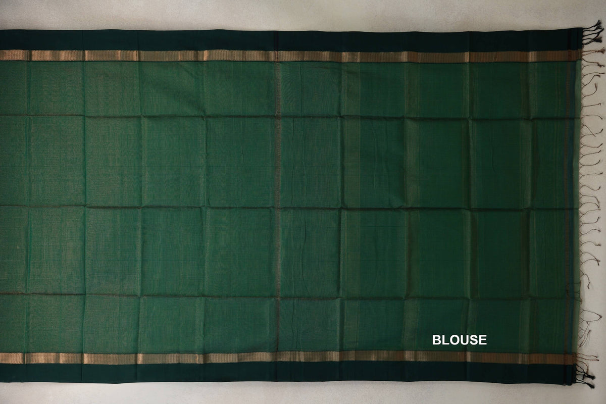 Bottle green Maheshwari silk cotton blouse fabric laid flat, with dark bottle green borders, narrow gold-toned stripes and tassels at one end.